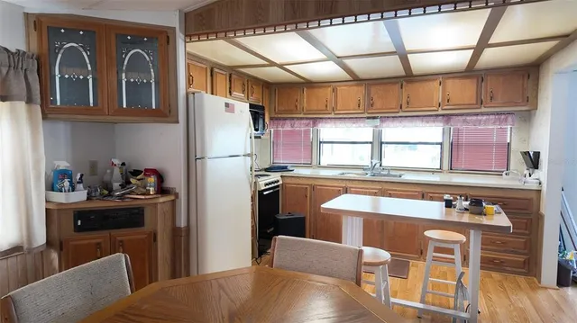 a kitchen with stainless steel appliances granite countertop a refrigerator and a stove top oven