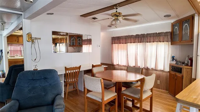 a view of a dining room with furniture and a window