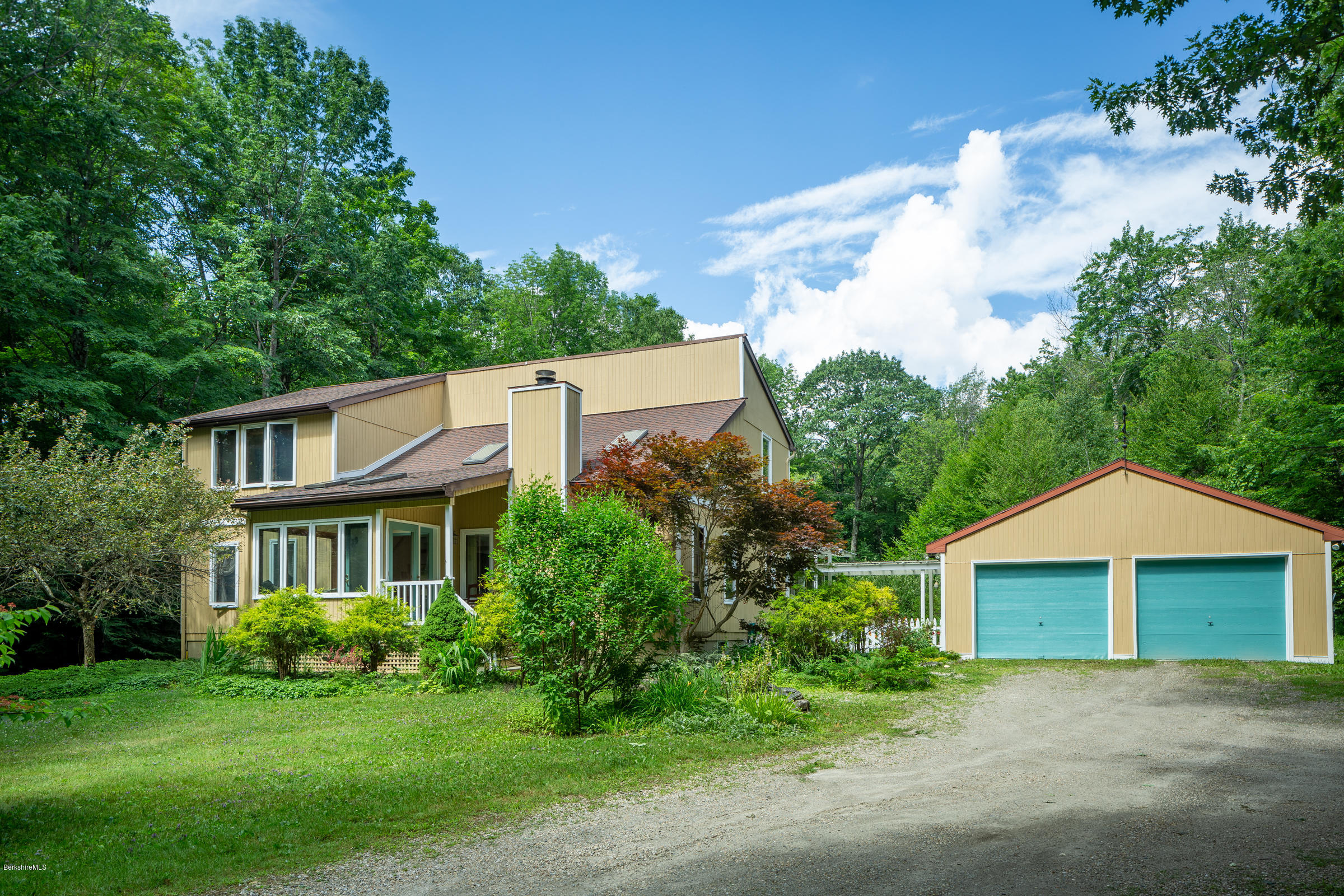 23 Griswold Road Monterey, MA 01245 - Photo 1 of 23 a front view of a house with a yard and garage