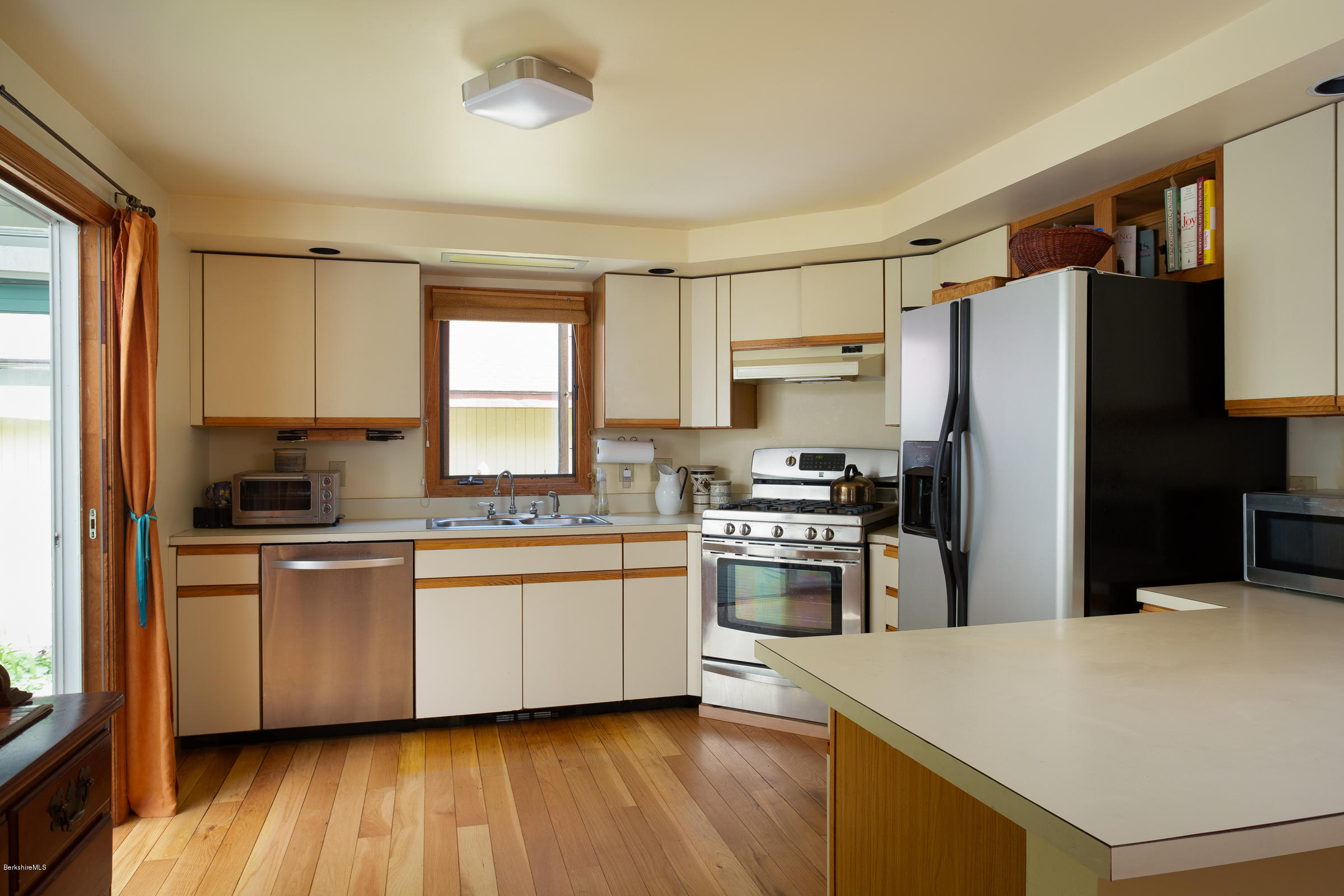 23 Griswold Road Monterey, MA 01245 - Photo 10 of 23 a kitchen with stainless steel appliances a sink cabinets and wooden floor