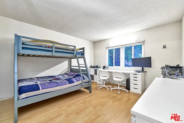 a bedroom with furniture and a wooden floor