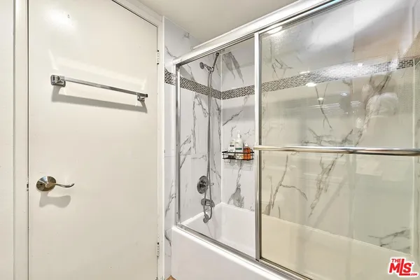 a bathroom with a shower and a sink