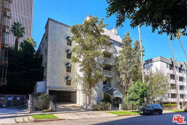 a view of a tall building with a tree in front of it