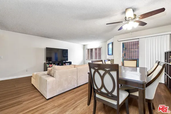 a living room with furniture a flat screen tv and a window