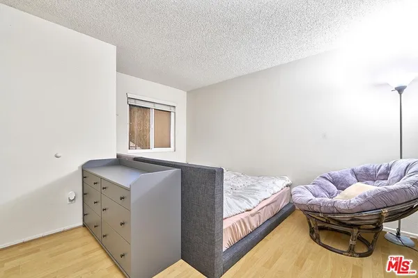 a bedroom with furniture and a window
