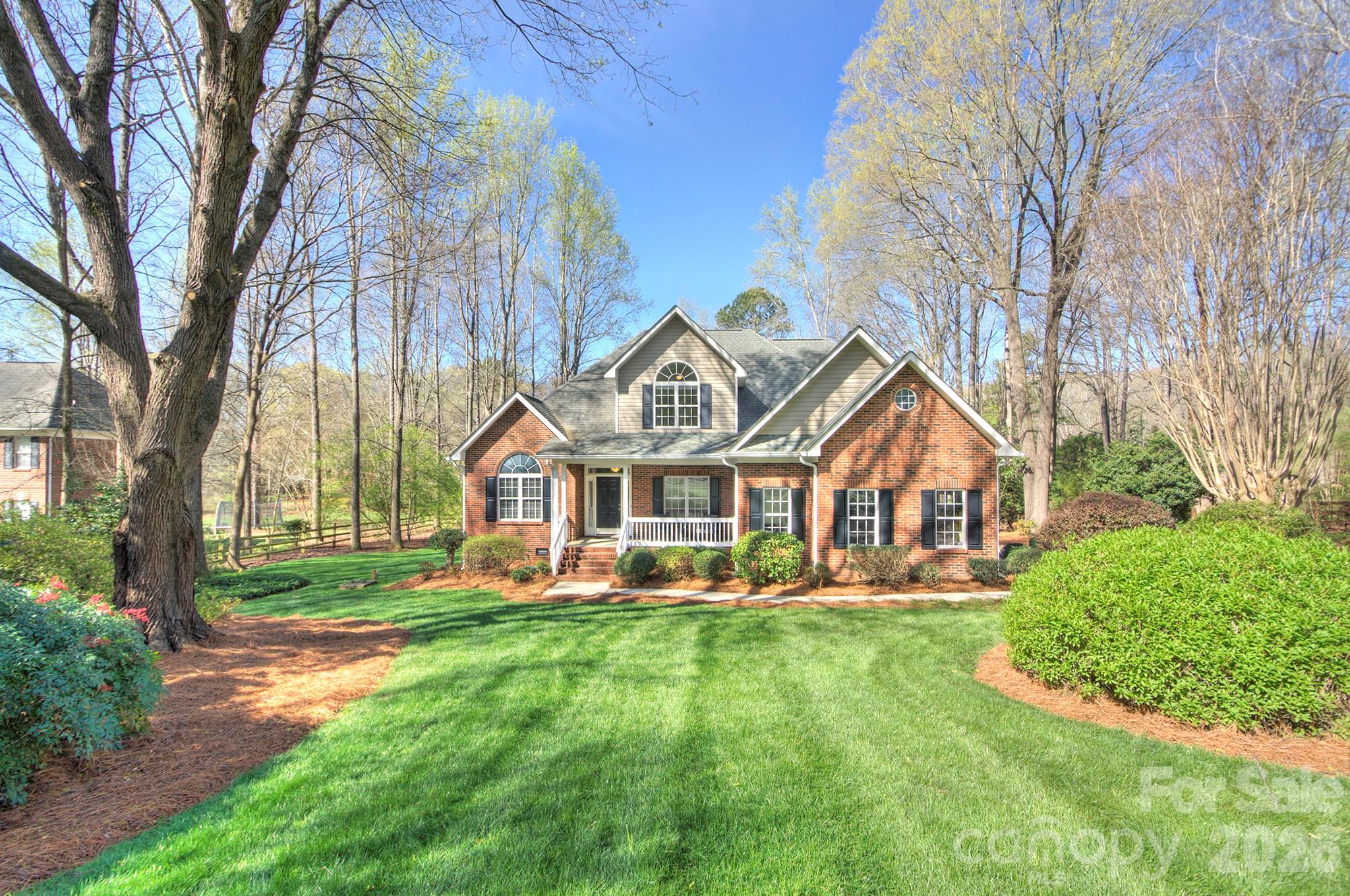4839 Antioch Church Road Matthews, NC 28104 - Photo 1 of 36 a front view of a house with a yard table and chairs
