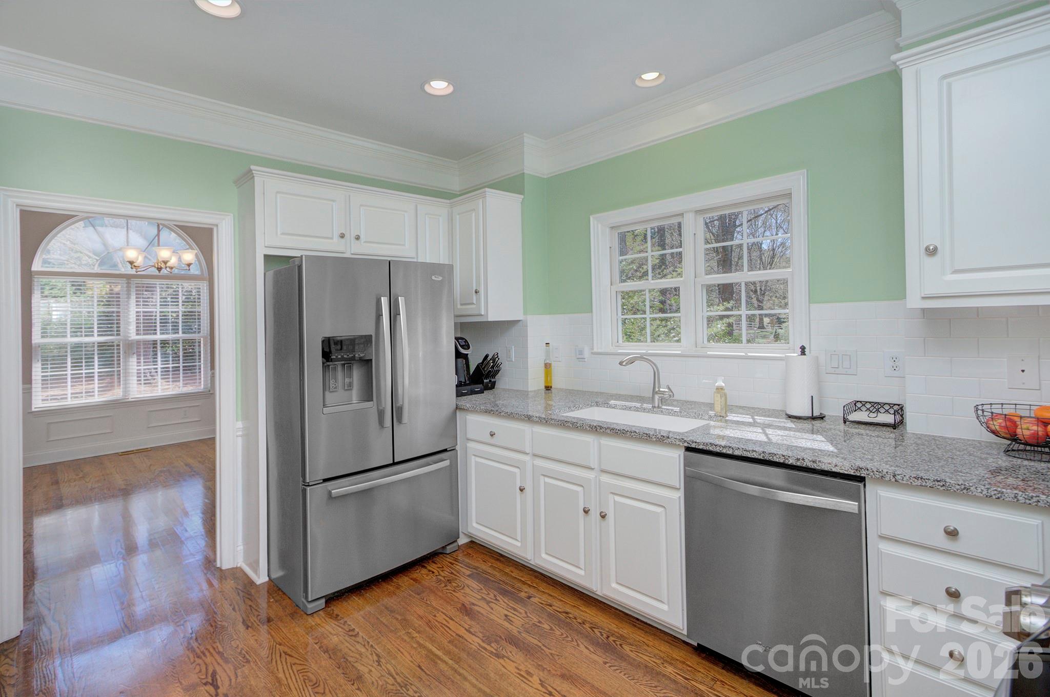 4839 Antioch Church Road Matthews, NC 28104 - Photo 17 of 36 a kitchen with a sink cabinets stainless steel appliances and a window