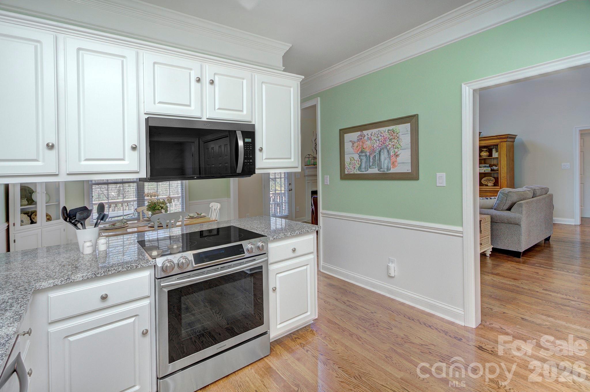 4839 Antioch Church Road Matthews, NC 28104 - Photo 18 of 36 a kitchen with granite countertop a stove and a microwave