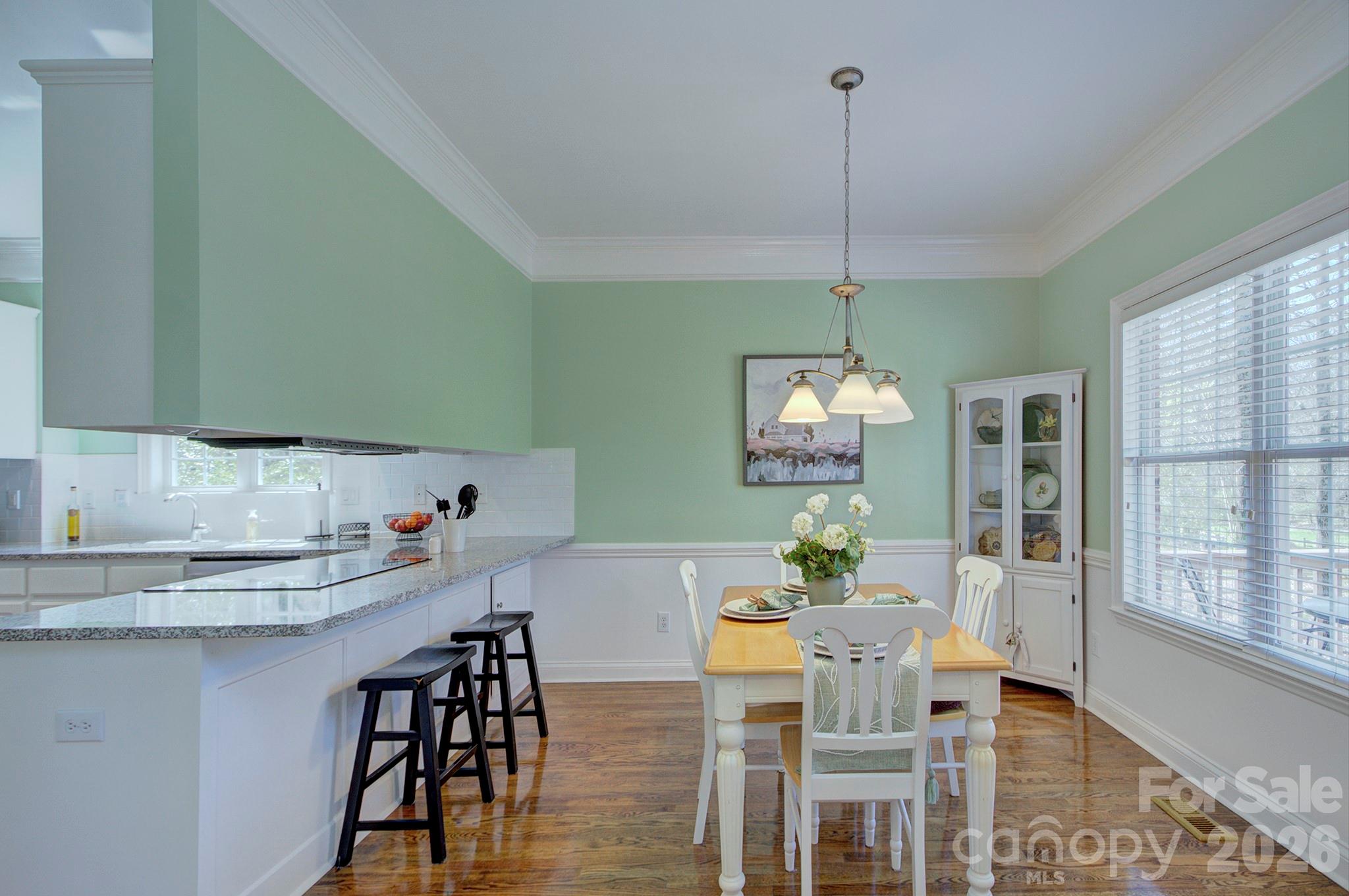 4839 Antioch Church Road Matthews, NC 28104 - Photo 19 of 36 a dining room with furniture a chandelier and wooden floor