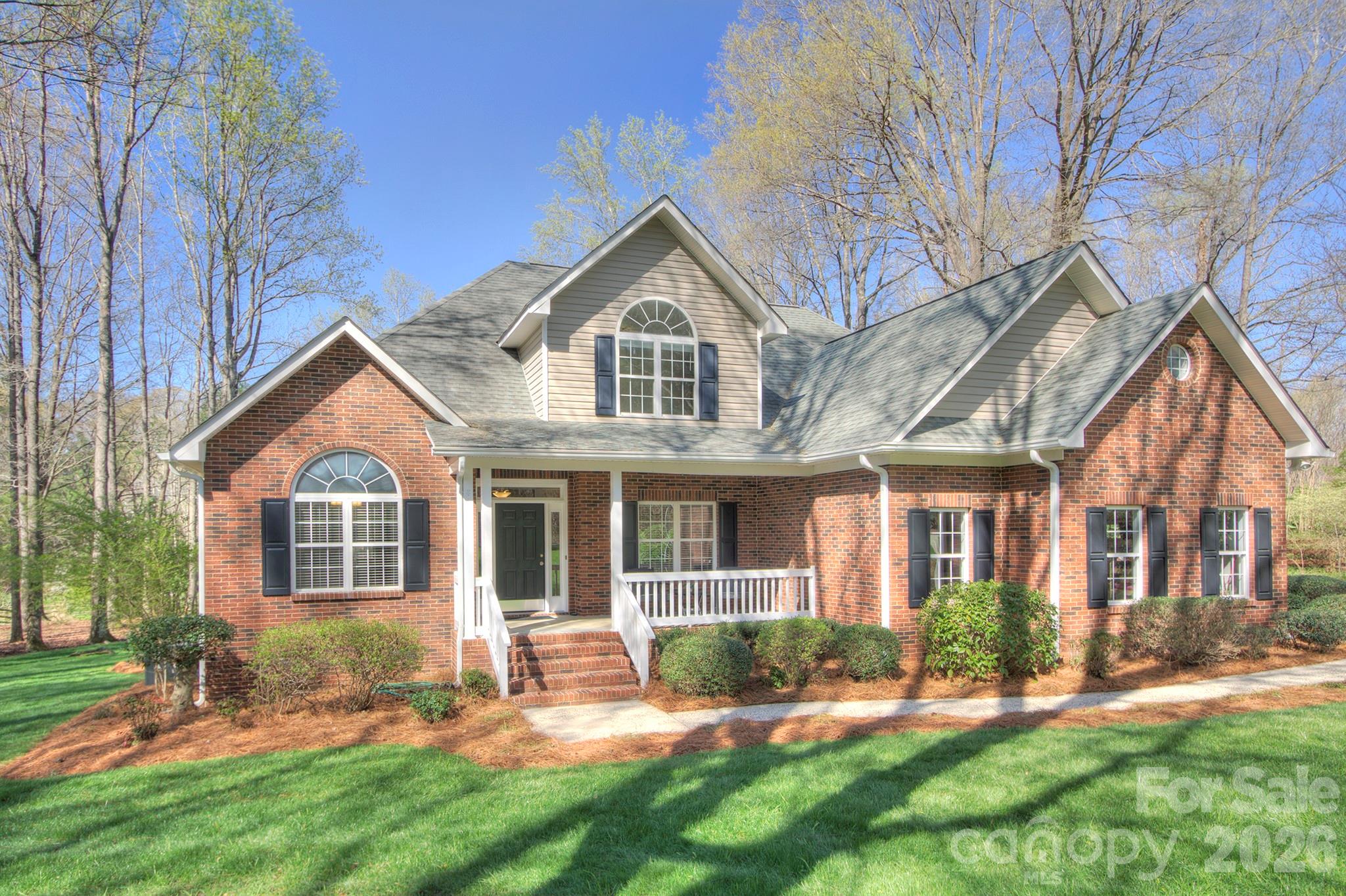 4839 Antioch Church Road Matthews, NC 28104 - Photo 2 of 36 a front view of a house with a yard and trees