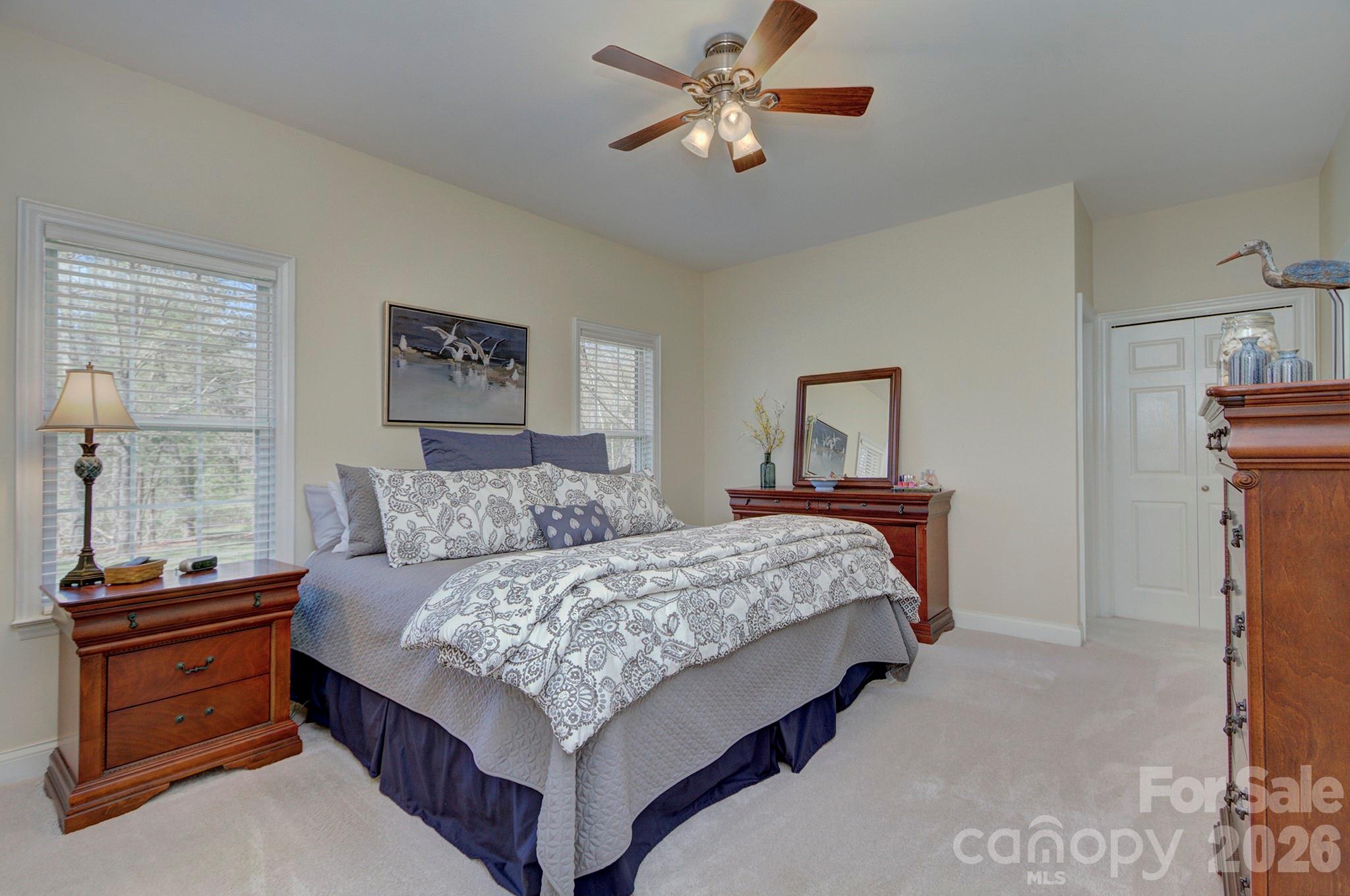 4839 Antioch Church Road Matthews, NC 28104 - Photo 23 of 36 a bedroom with a bed and a chandelier