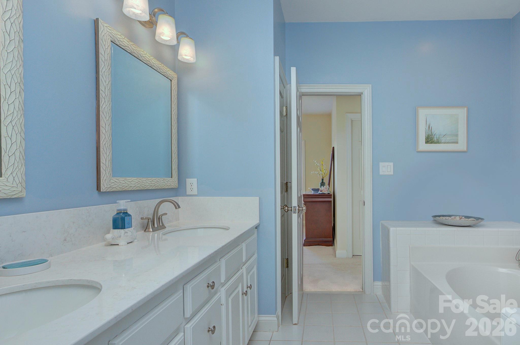 4839 Antioch Church Road Matthews, NC 28104 - Photo 24 of 36 a bathroom with a sink double vanity and a tub