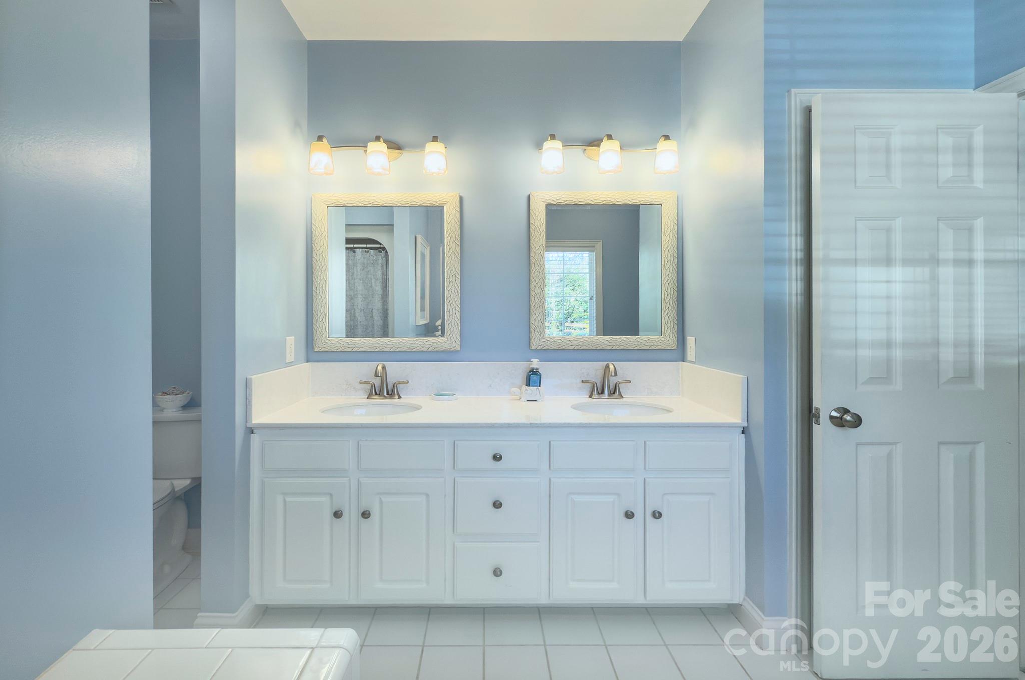 4839 Antioch Church Road Matthews, NC 28104 - Photo 26 of 36 a bathroom with double vanity sinks and a mirror