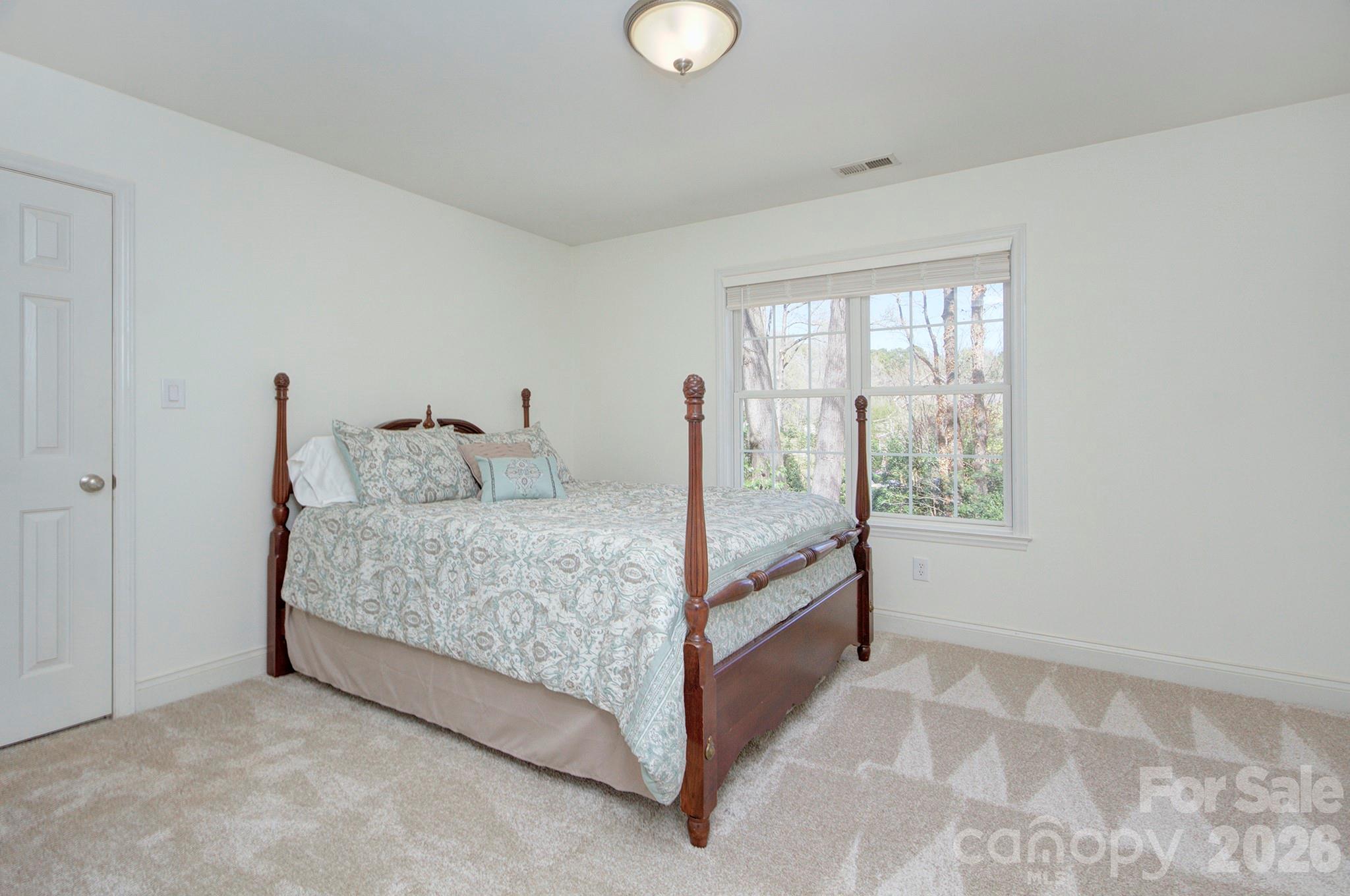 4839 Antioch Church Road Matthews, NC 28104 - Photo 31 of 36 a bedroom with a bed and window