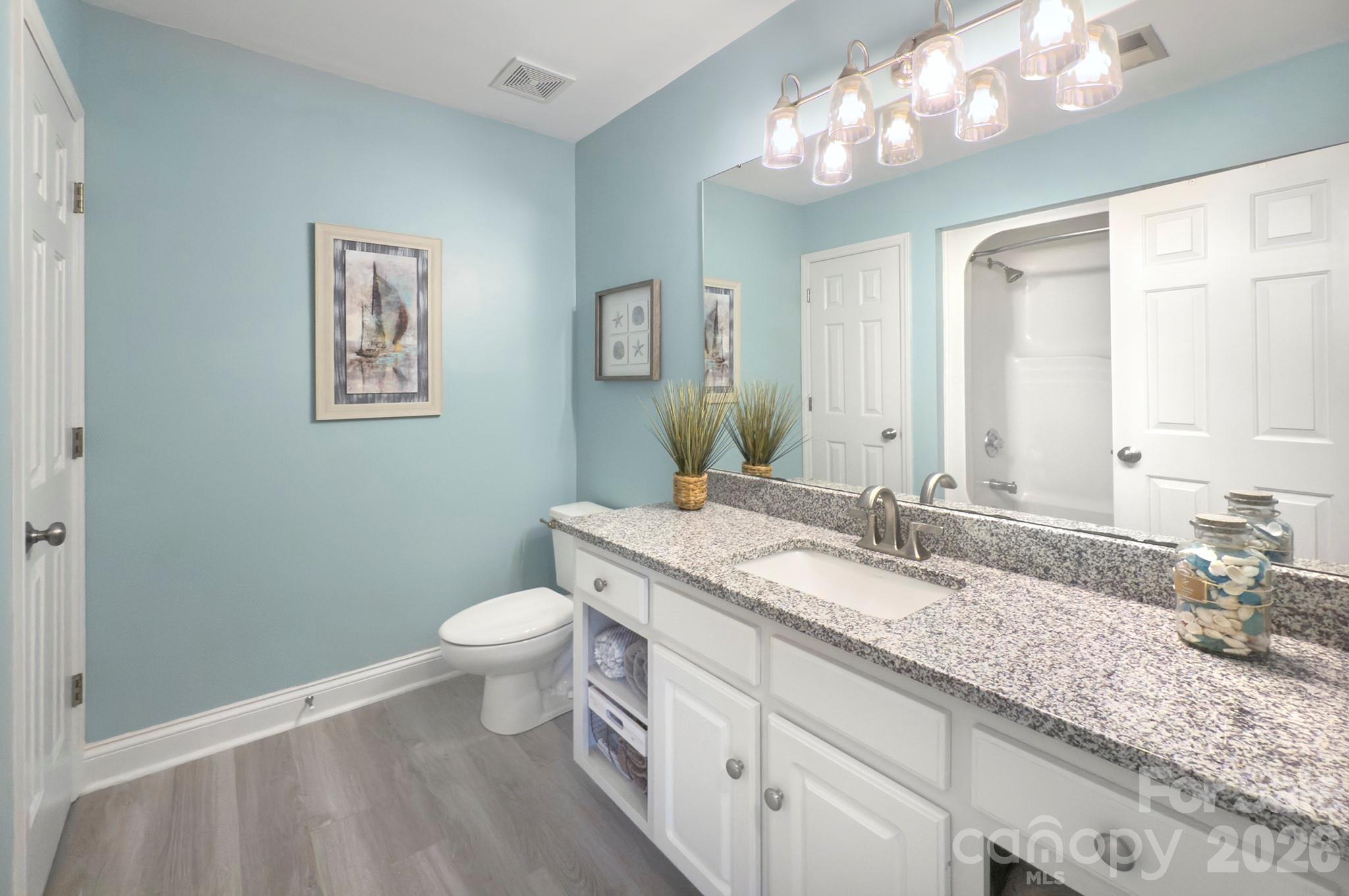 4839 Antioch Church Road Matthews, NC 28104 - Photo 32 of 36 a bathroom with a granite countertop sink and a mirror