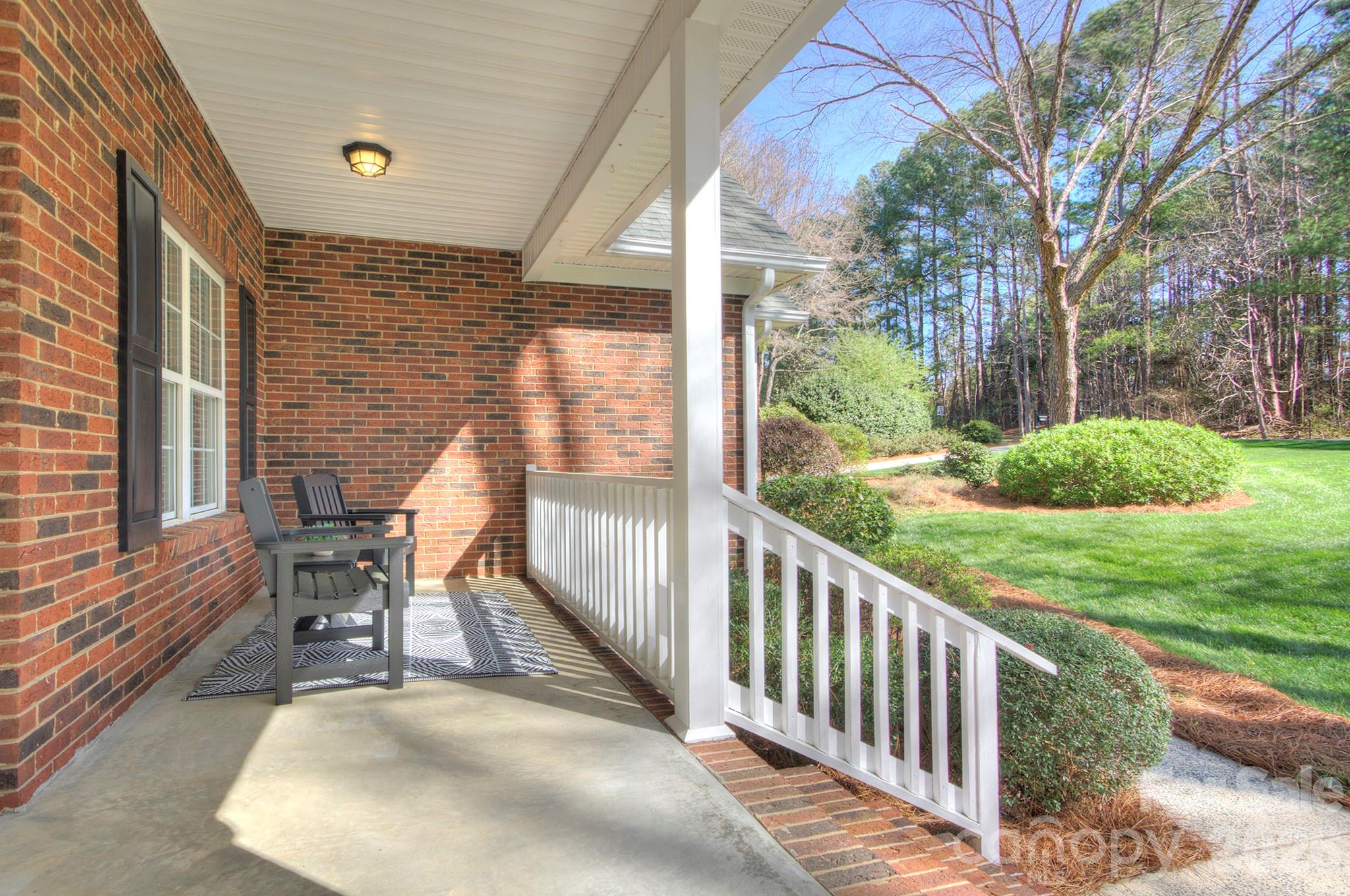 4839 Antioch Church Road Matthews, NC 28104 - Photo 4 of 36 a view of a porch with furniture and garden