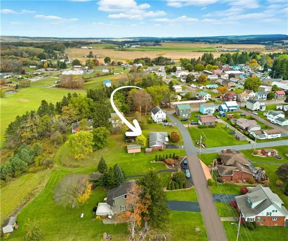 an aerial view of residential houses with outdoor space