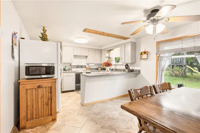 a kitchen with kitchen island a stove a sink and a refrigerator