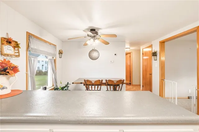 a view of a counter space with a sink and chandelier