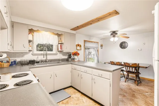 a kitchen with a sink cabinets and window