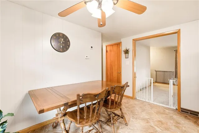 a view of a dining room with furniture and a chandelier