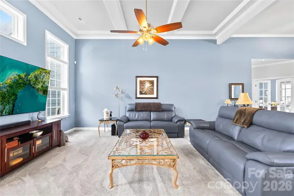 a living room with furniture and kitchen view