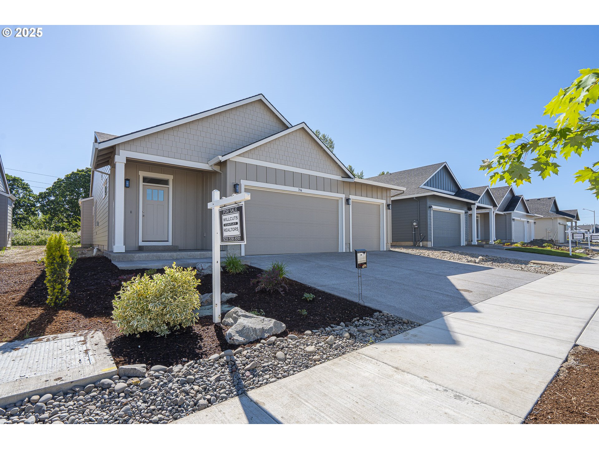 714 Tigerlily Street Silverton, OR 97381 - Photo 3 of 36 a front view of a house with a yard and a garden