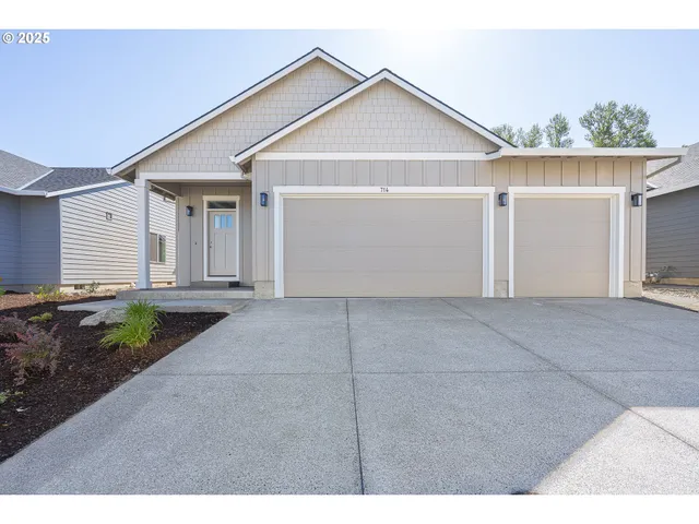a view of a house with a yard and garage