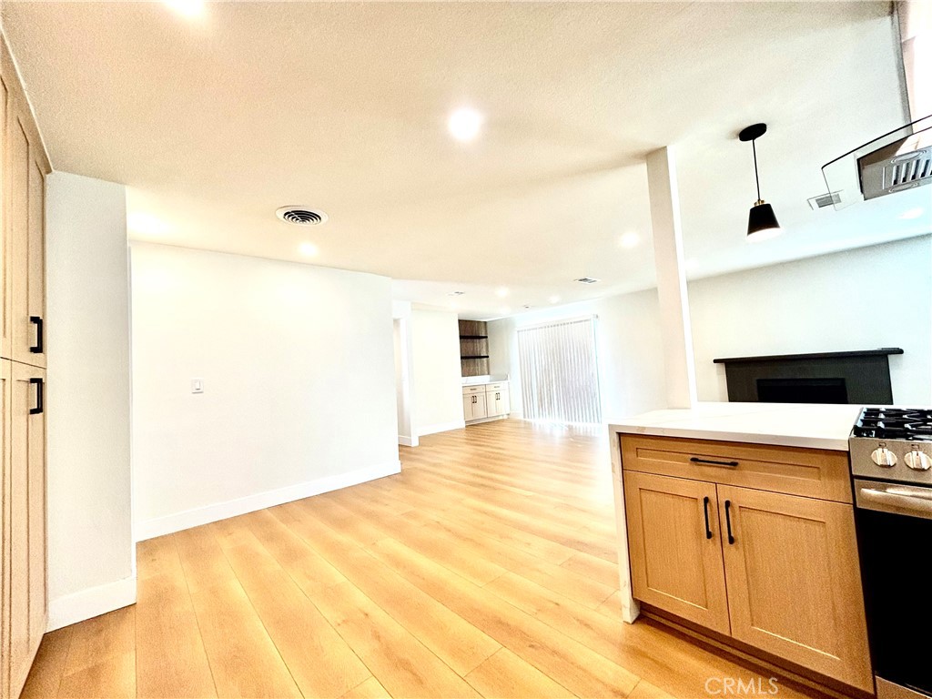 6210 Halstead Avenue, Unit A Rancho Cucamonga, CA 91701 - Photo 18 of 32 a view of a kitchen with wooden floor and a sink
