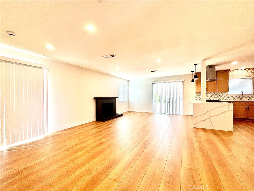 6210 Halstead Avenue, Unit A Rancho Cucamonga, CA 91701 - Photo 29 of 32 a view of empty room with wooden floor and seating space