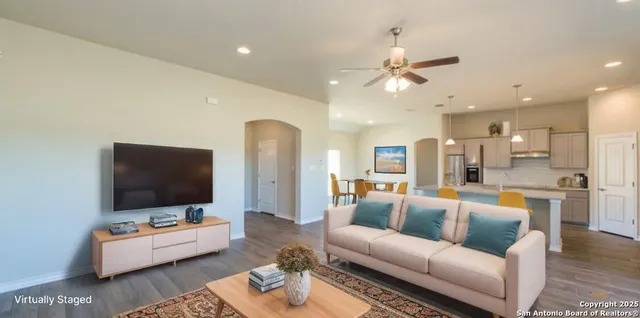 a living room with furniture and a flat screen tv