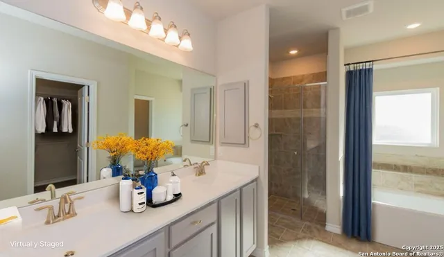 a bathroom with a sink double vanity and a mirror