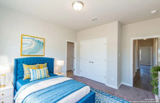 a bedroom with a bed and a painting on the wall