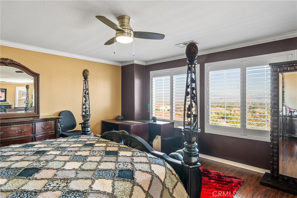 18458 Hidden Ranch Road Riverside, CA 92508 - Photo 13 of 30 a bedroom with a bed and wooden floor