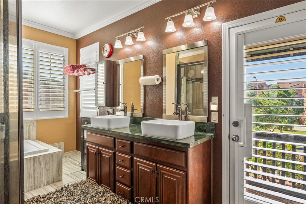 18458 Hidden Ranch Road Riverside, CA 92508 - Photo 14 of 30 a bathroom with a double vanity sink and a mirror