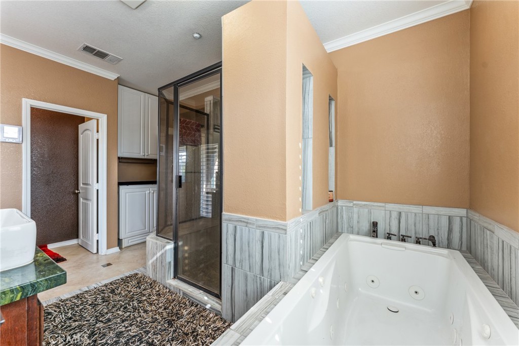 18458 Hidden Ranch Road Riverside, CA 92508 - Photo 16 of 30 a bathroom with a bathtub and a shower