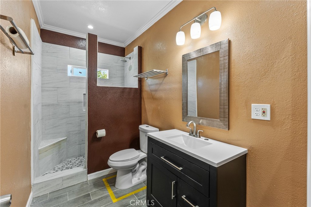 18458 Hidden Ranch Road Riverside, CA 92508 - Photo 24 of 30 a bathroom with a sink toilet a mirror and shower