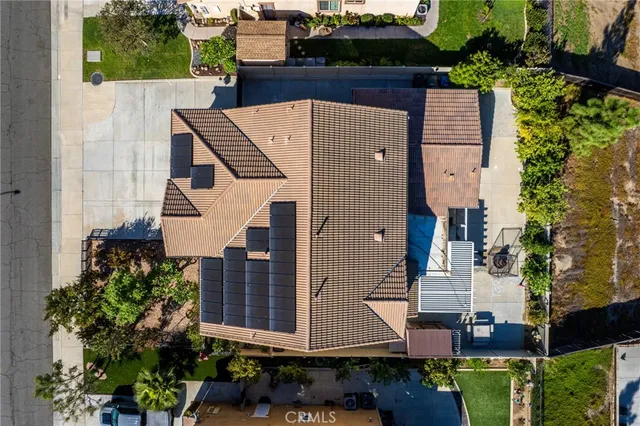 an aerial view of a house with a yard and potted plants