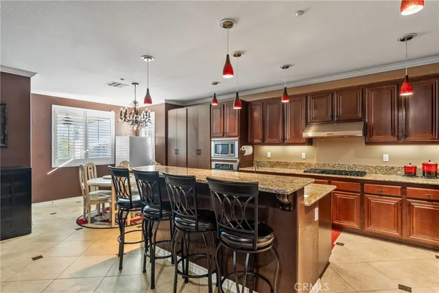 a kitchen with a table chairs sink and cabinets