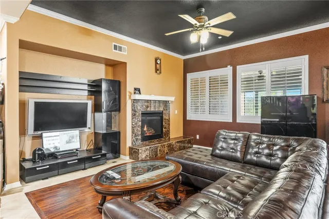 a living room with furniture a flat screen tv and a large window