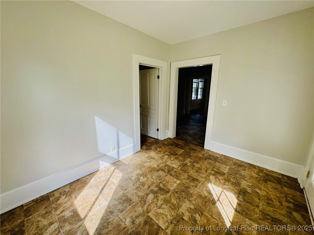 907 Caldwell Street, Unit A Lumberton, NC 28358 - Photo 11 of 24 a view of a big room with closet and wooden floor