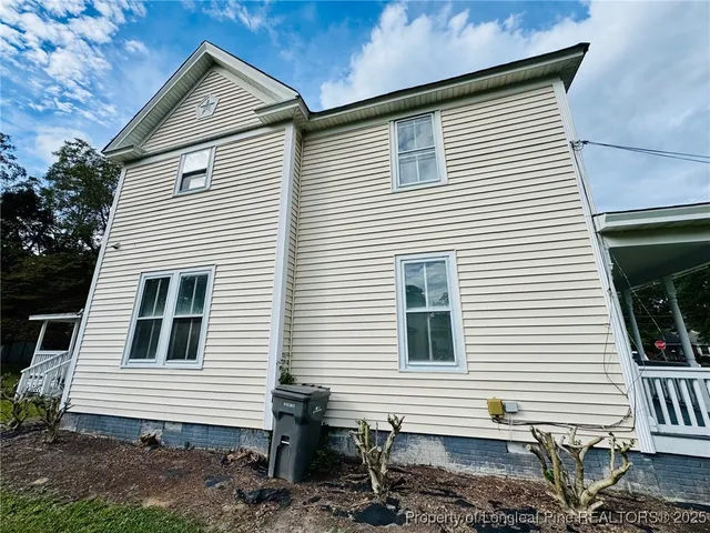 a view of a house with a yard and stairs