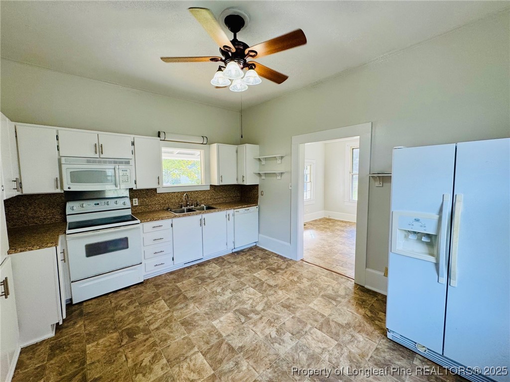 907 Caldwell Street, Unit A Lumberton, NC 28358 - Photo 6 of 24 a kitchen with stainless steel appliances a refrigerator and cabinets
