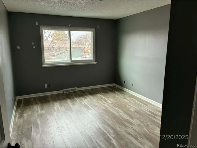 an empty room with windows and closet