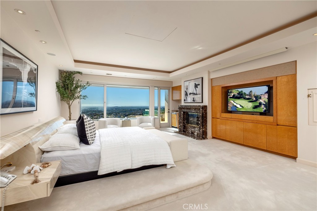 3 Seashell Newport Coast, CA 92657 - Photo 14 of 36 a bedroom with a large bed and a flat screen tv