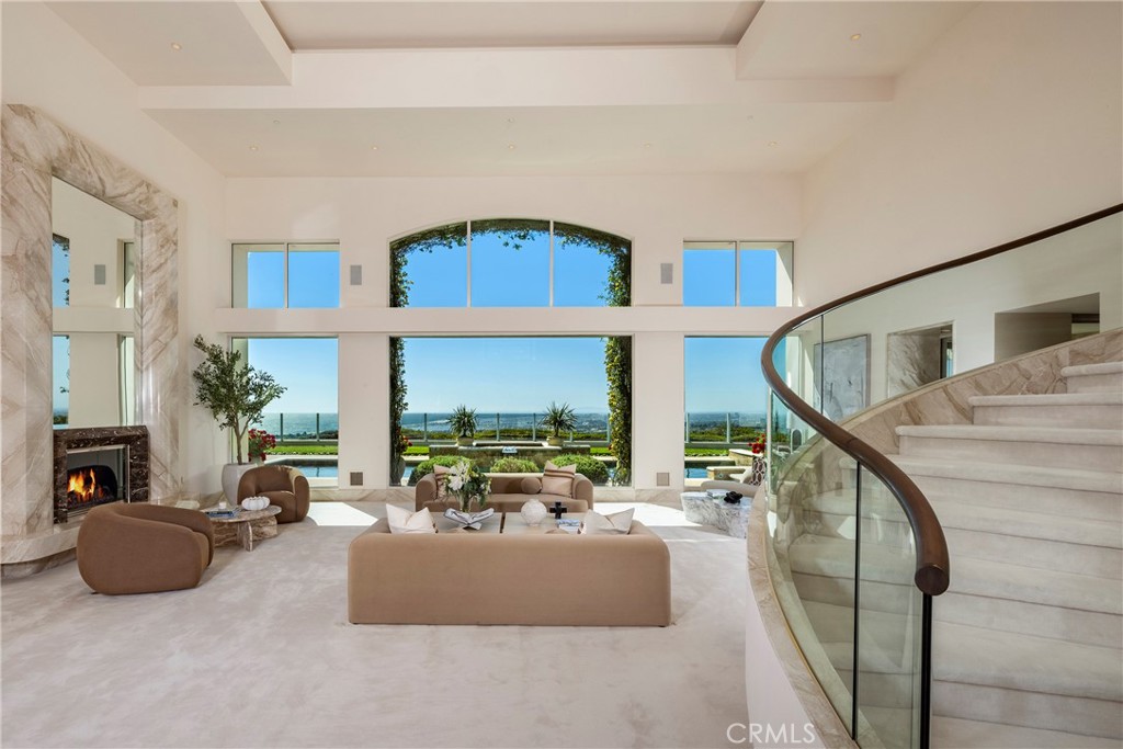 3 Seashell Newport Coast, CA 92657 - Photo 6 of 36 a living room with furniture a fireplace and a large window