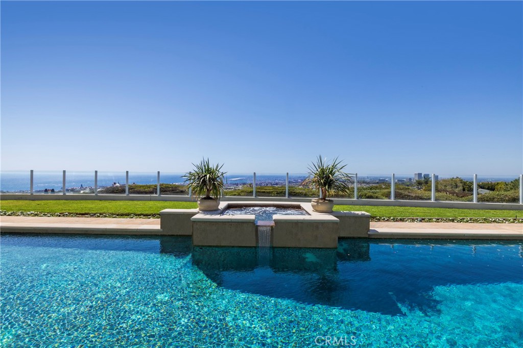 3 Seashell Newport Coast, CA 92657 - Photo 10 of 36 a view of a swimming pool with lawn chairs and a big yard