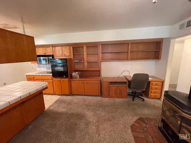 a workspace with furniture and a gate