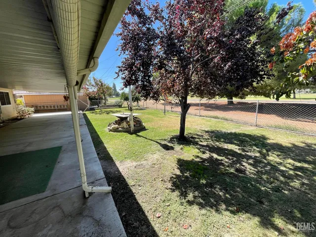a view of a house with floor to ceiling windows and a table