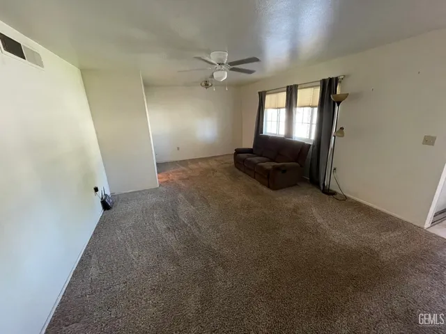 a view of a livingroom with furniture and windows